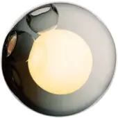 Spherical pendant light, polished metal, featuring an opaque inner sphere emitting warm yellow light and subtle organic form.